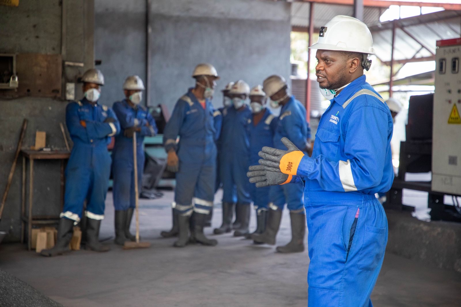 Workers in hard hats and safety gear in a training session